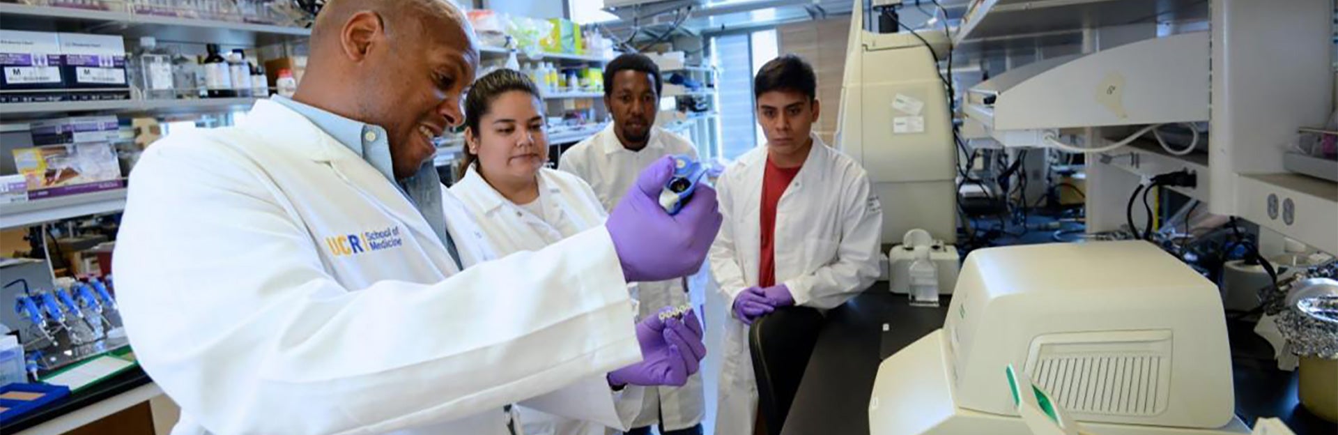 students in the lab with mentor